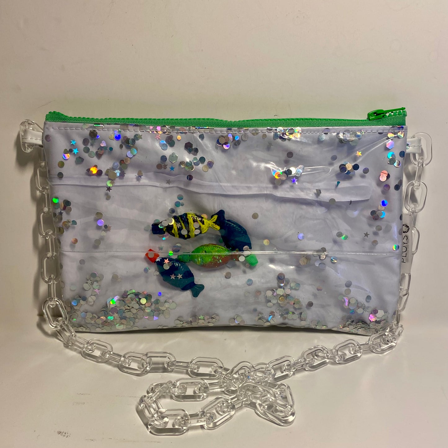 White and Silver glitter purse with soy fish displayed in sustainably made from upcycled pool inflatables