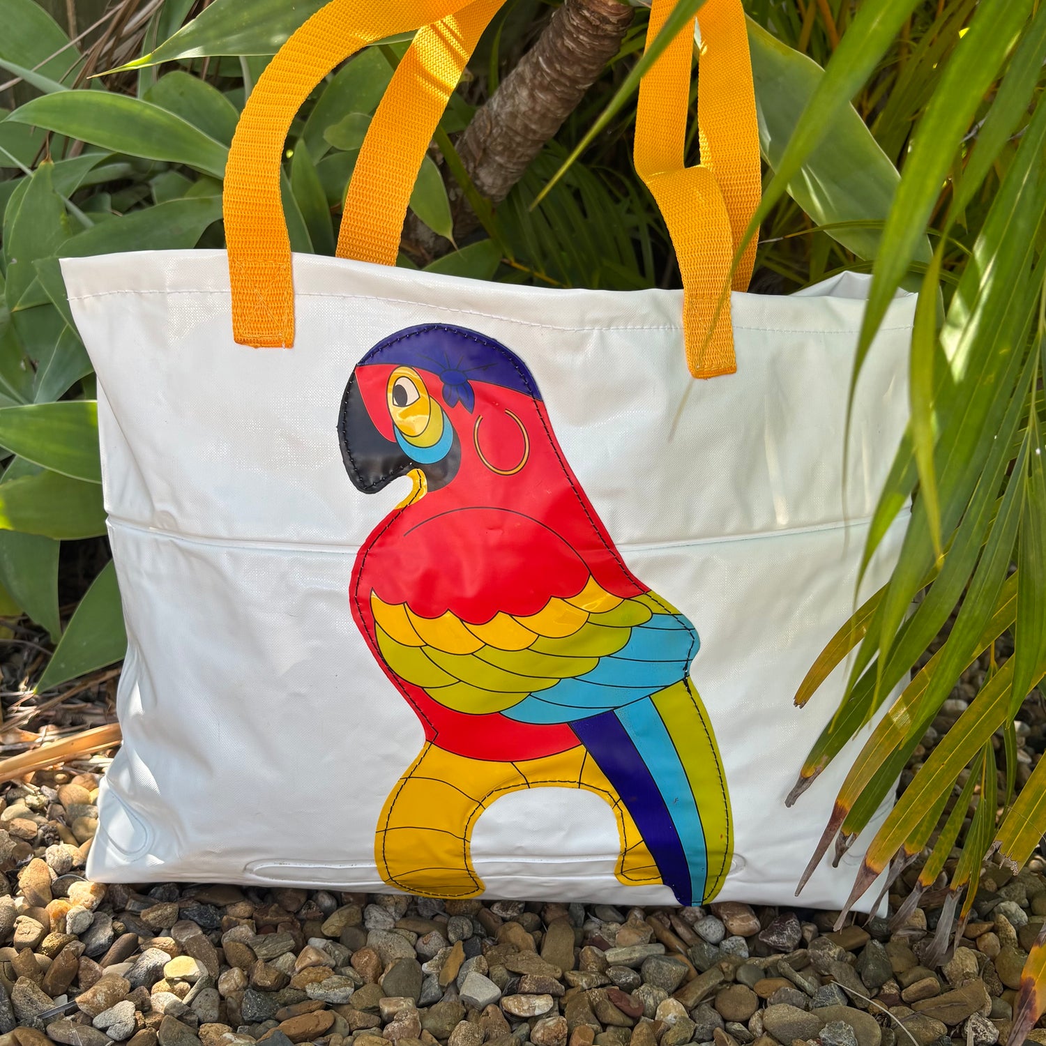 White tote beach bag made from upcycled inflatables with a colorful parrot inflatable tropical bird