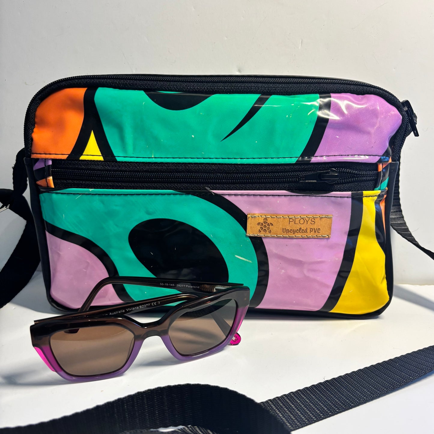 Upcycled cross body bag made from repurposed inflatables in bold colours