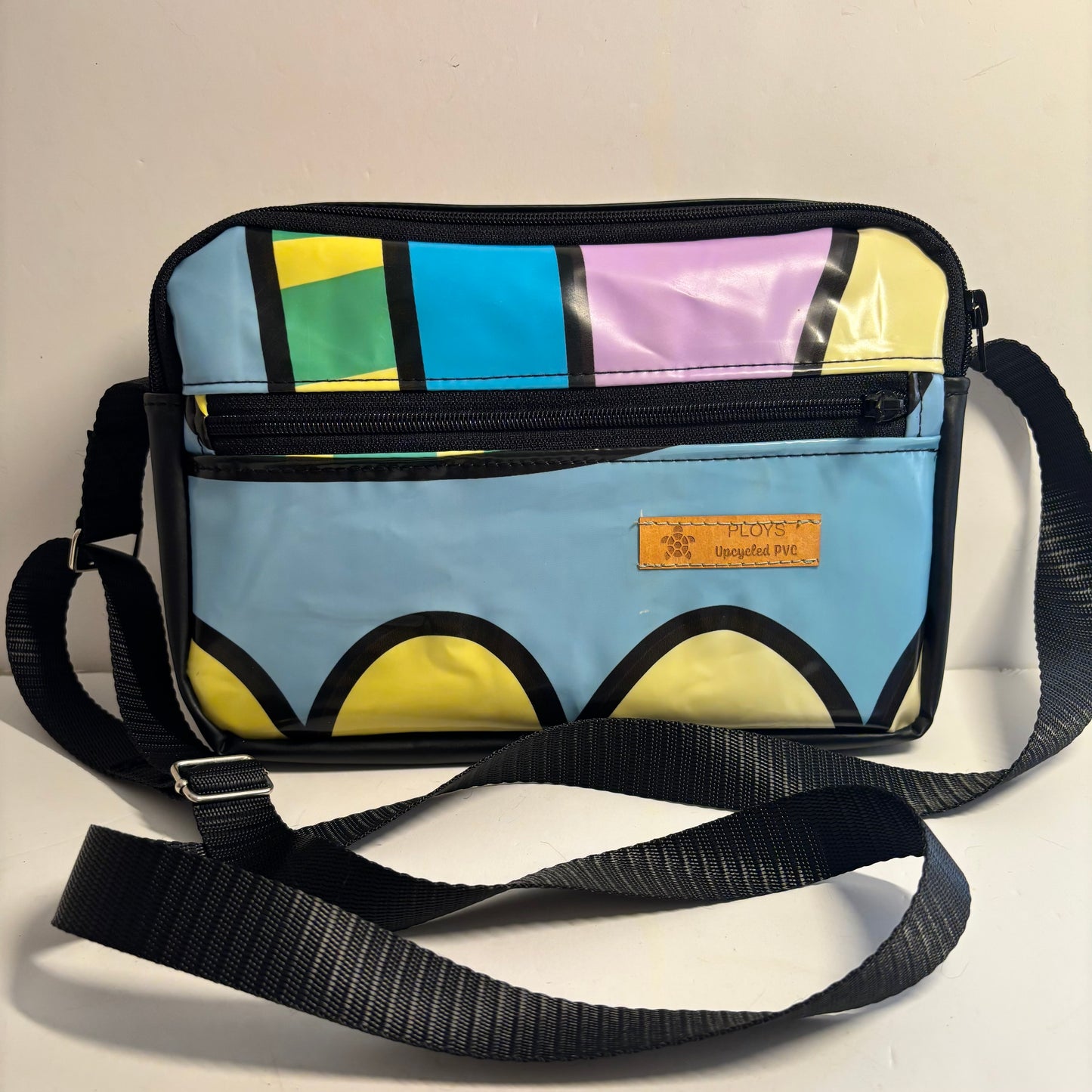 Upcycled cross body bag made from repurposed inflatables in bold colours