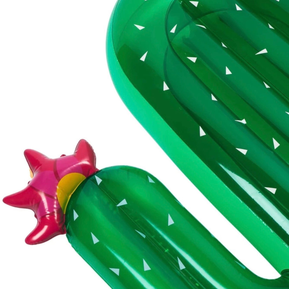 An inflatable pool float shaped like a green cactus with white splotches, a pink star-shaped flower on the left, before it was upcycled into a bag.