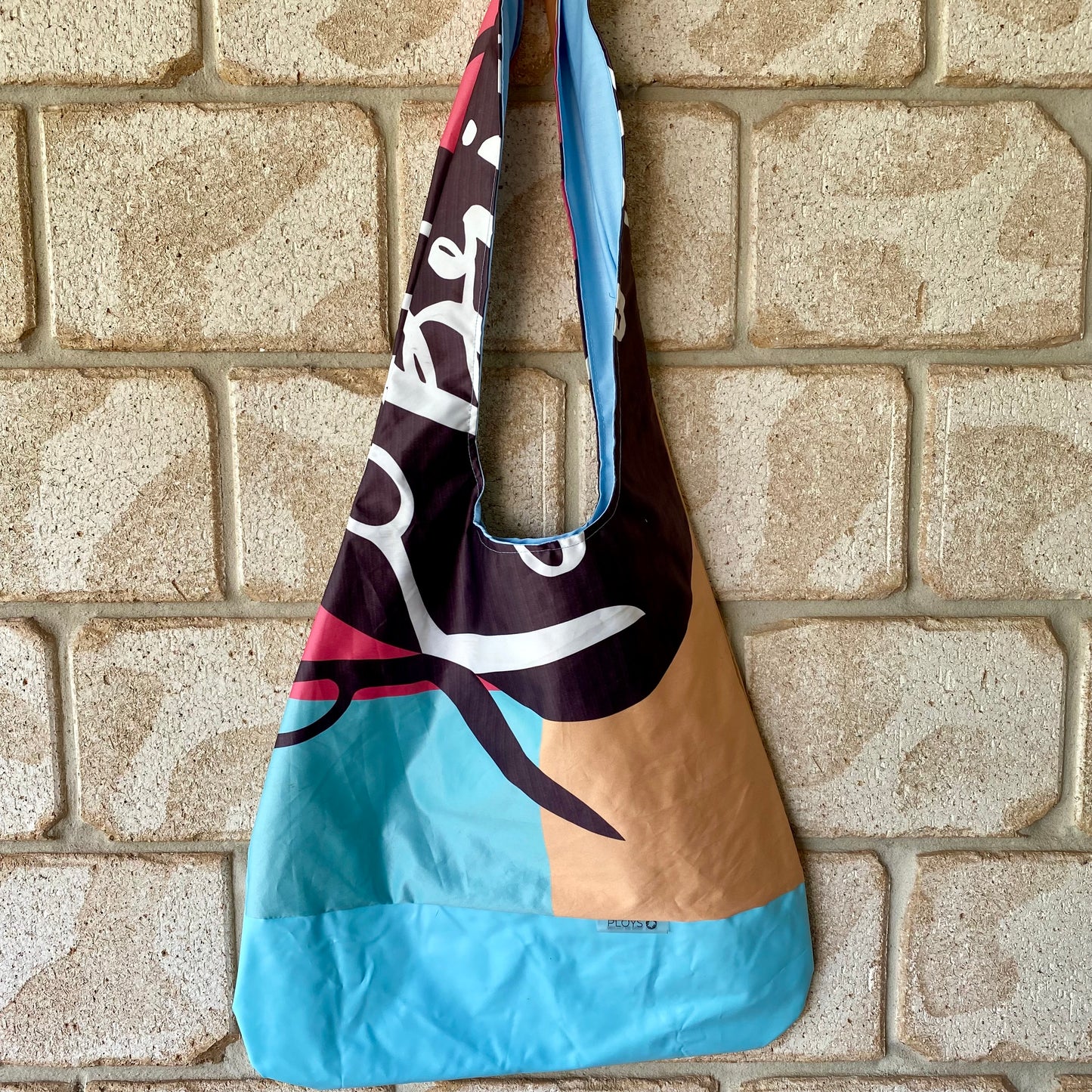 Unique Brisstyle shoulder bag in boho hobo style made from recycled flags and banners fabrics