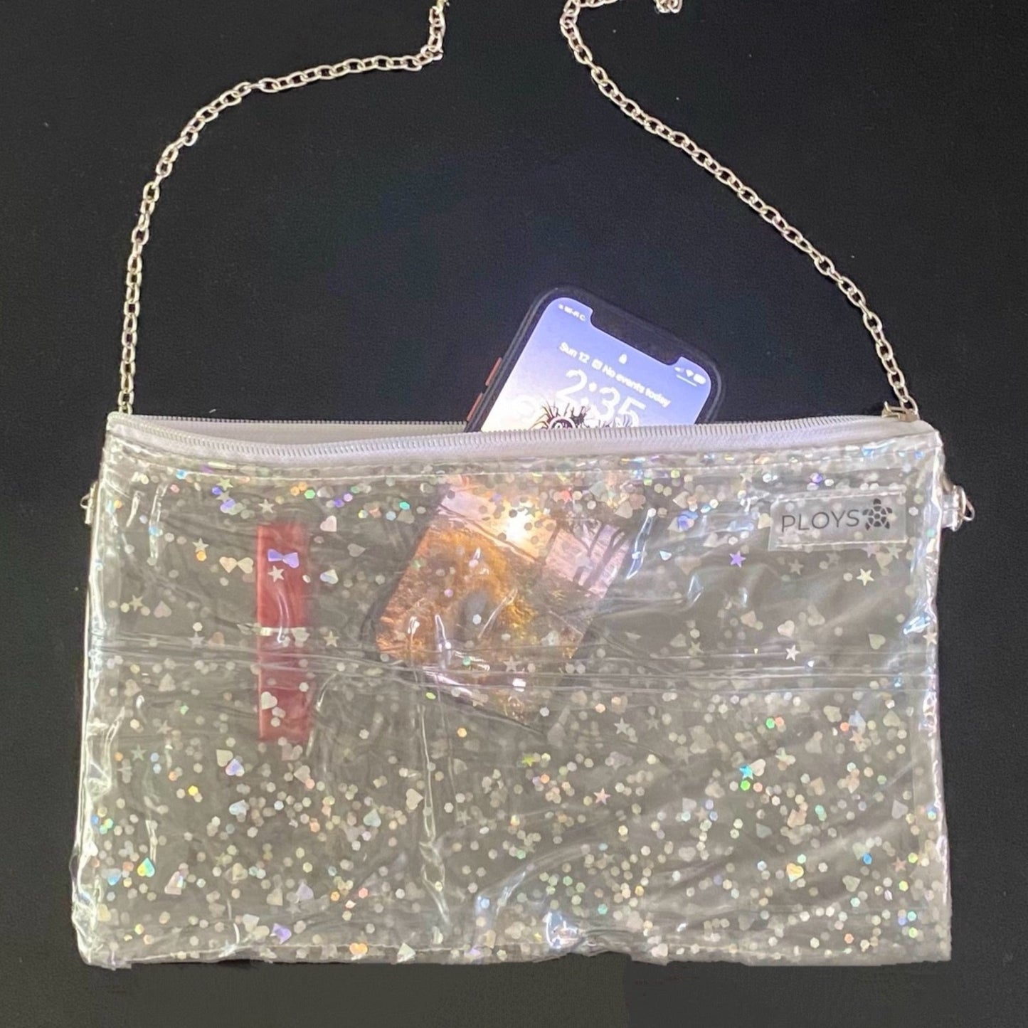 Mobile phone in transparent glitter purse sustainably made from upcycled pool inflatables