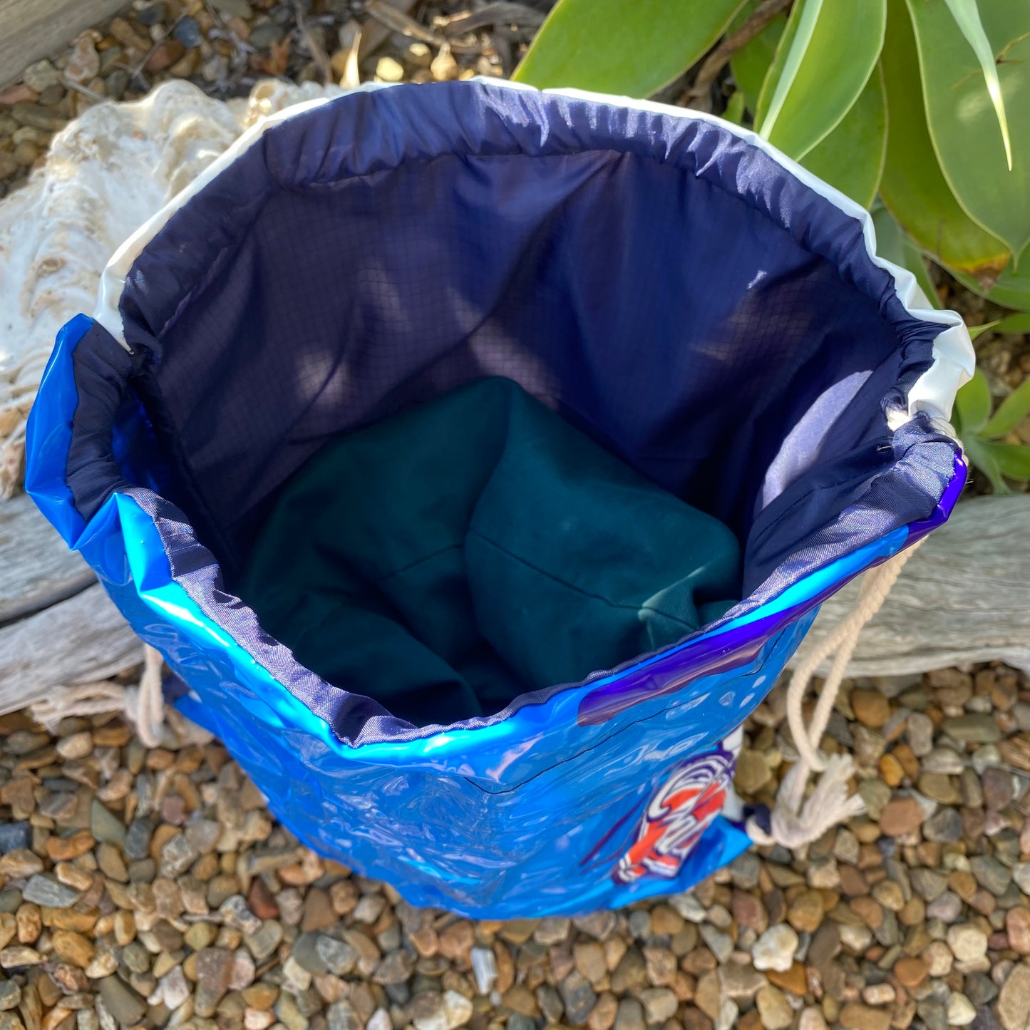 Swim bag made from recycled pool inflatables, lined with ripstop fabric. Perfect water resistant bag for swimming, sports and shop. Made from recycled PVC. Showing lined inside of bag.