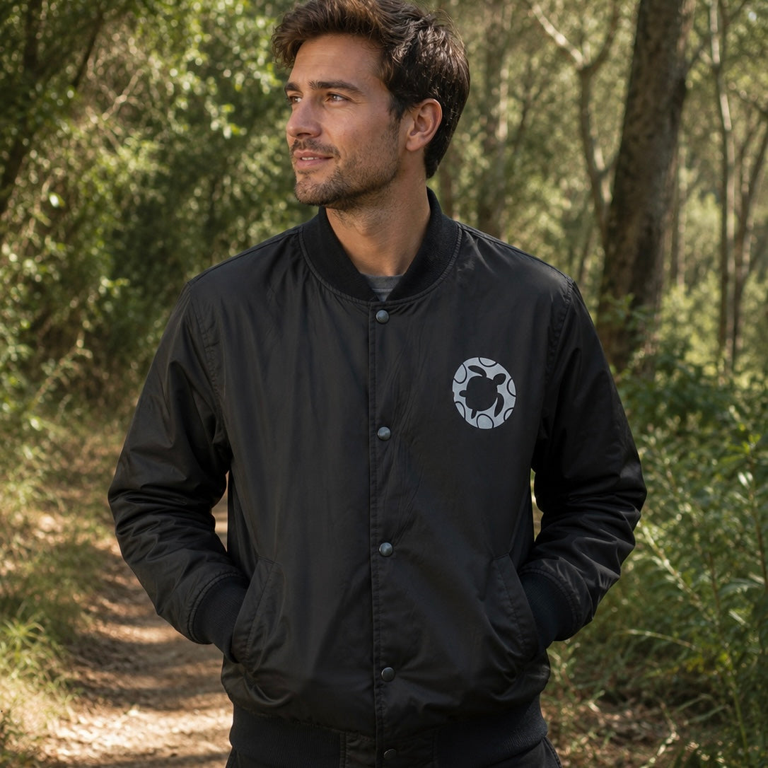 Bomber jacket made from 100% recycled plastic with turtle logo in black and white, warm for cooler temperatures