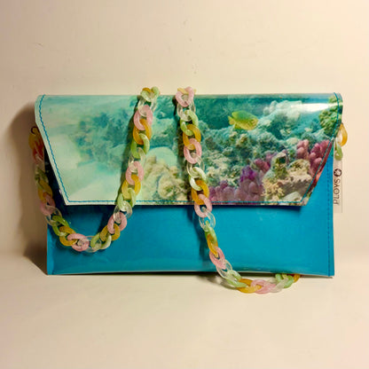 Vinyl art canvas clutch purse or cross body bag made from clear vinyl upcycled pvc sewn into sustainable purse Showing a coral reef scene