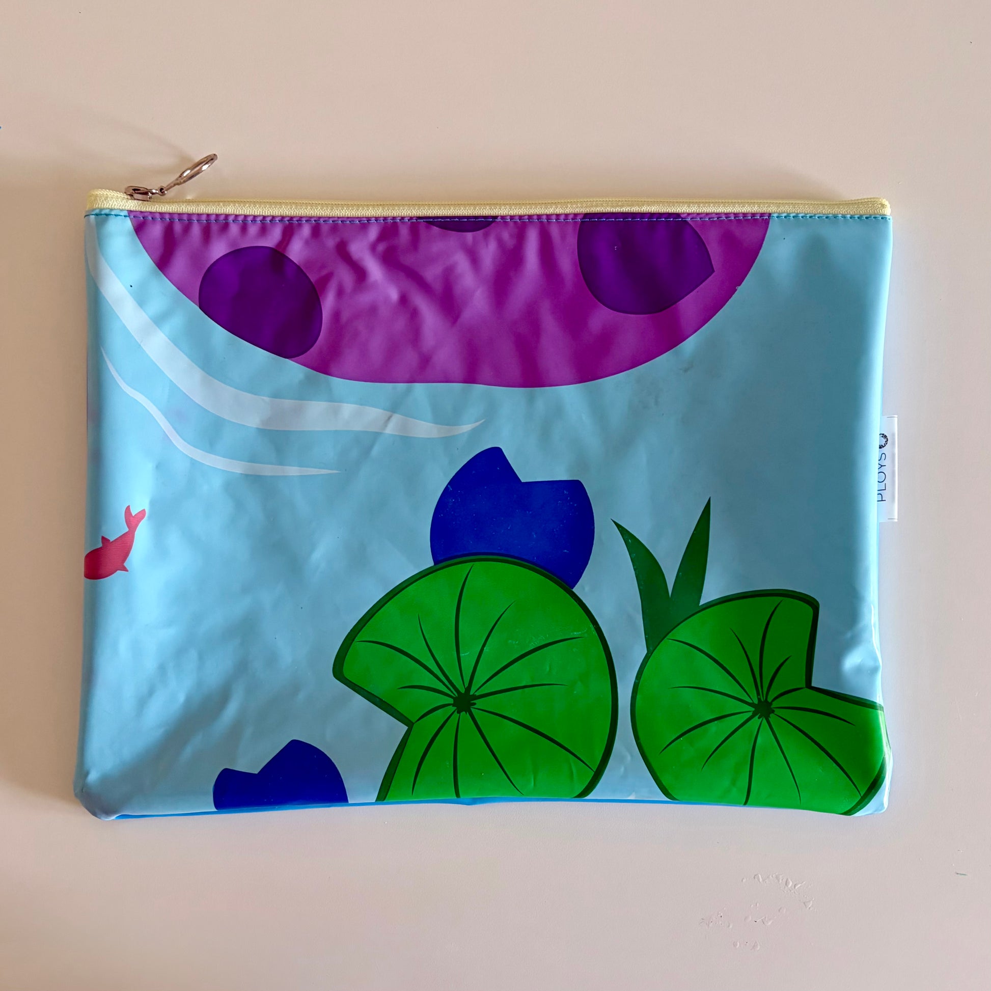 Waterproof Wet Bag made from recycled pool floats with bright fun lily pad fish pattern recycling plastic waste 