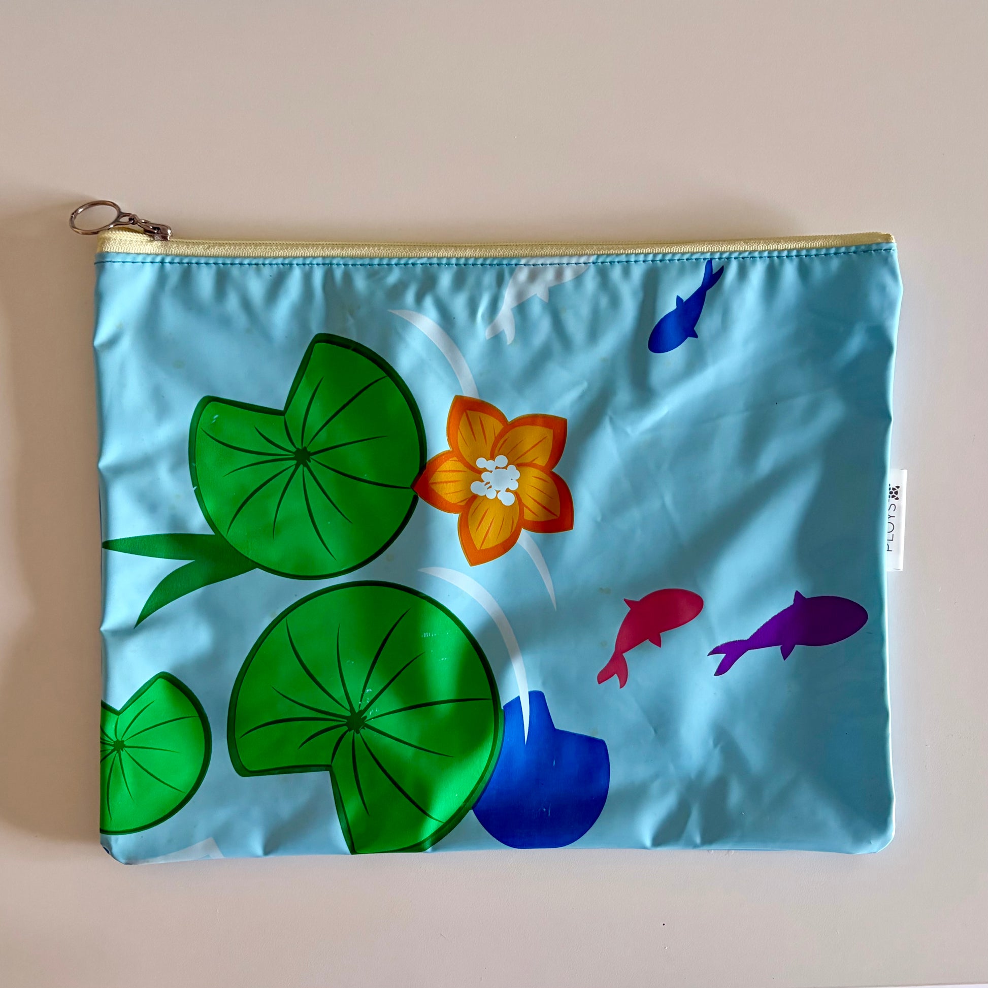Wet Bag waterproof made from recycled pool floats with bright fun lily pad fish pattern recycling plastic waste 