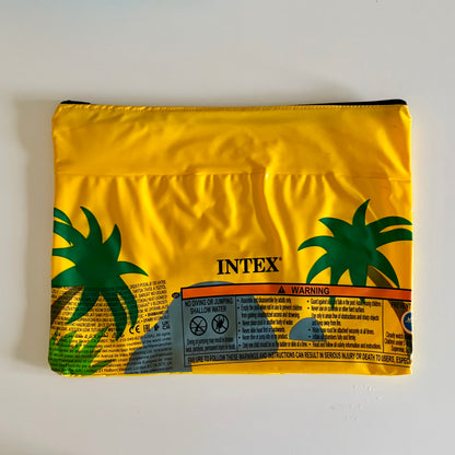 Yellow wet bag with palm tree scene made from pool inflatable for storing wet swimmers or use as travel pouch 