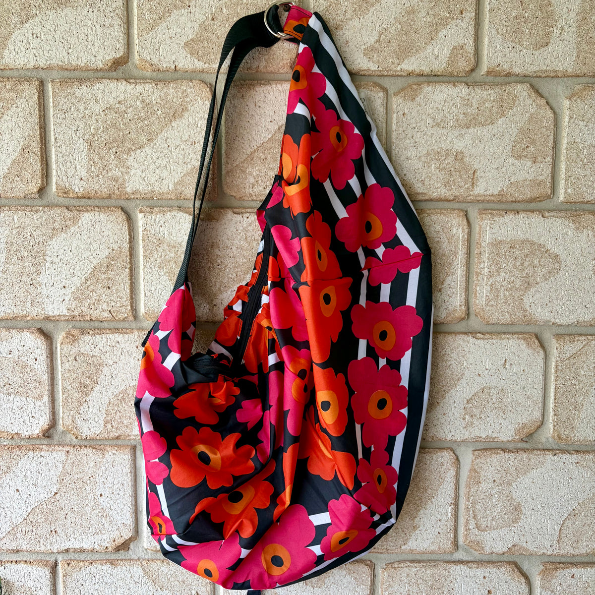 Tasuki duffel bag made from upcycled colourful marimeko style poppies umbrellas perfect weekend away, light waterproof and spacious with long adjustable shoulder strap.