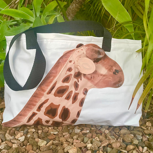 White upcycled pvc  bag with a giraffe design on a natural background