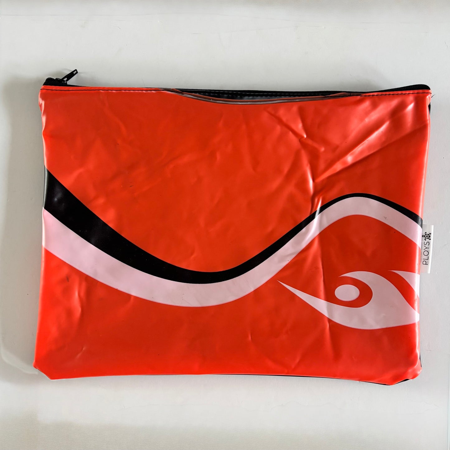 Wet Bag ideal for swimmers in orange with a black and white wave pattern made from an upcycled rubber boat 