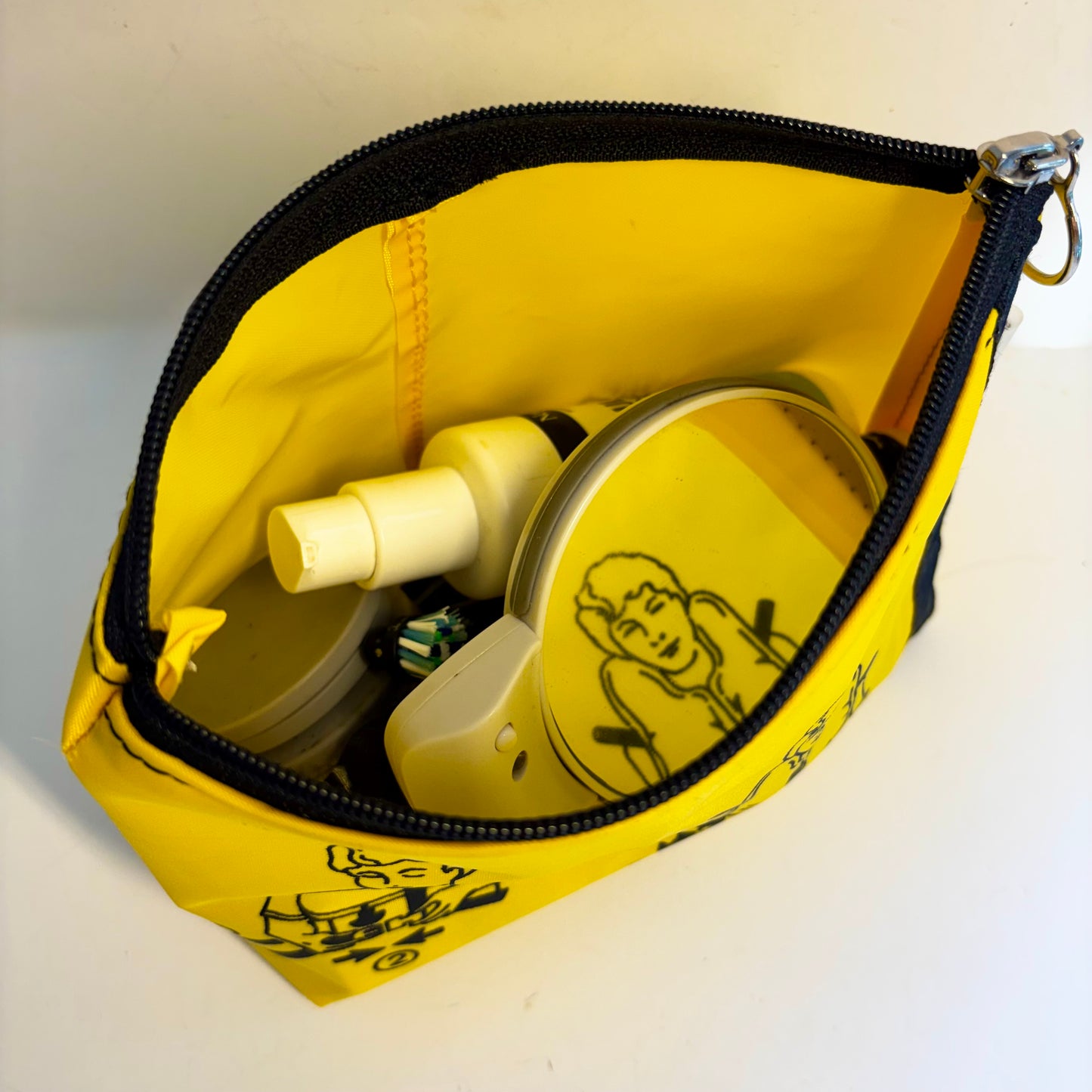 Cosmetics purse from upcycled airline life jacket, spacious, sturdy and lightweight made from recycled pvc and Kevlar material, featuring rescue safety images, unique utility bag for your travel or holiday! 