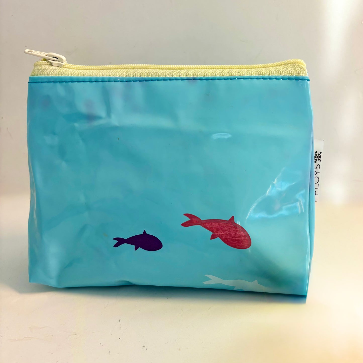 Upcycled cosmetics purse handmade from repurposed pool inflatables using recycled PVC plastic.