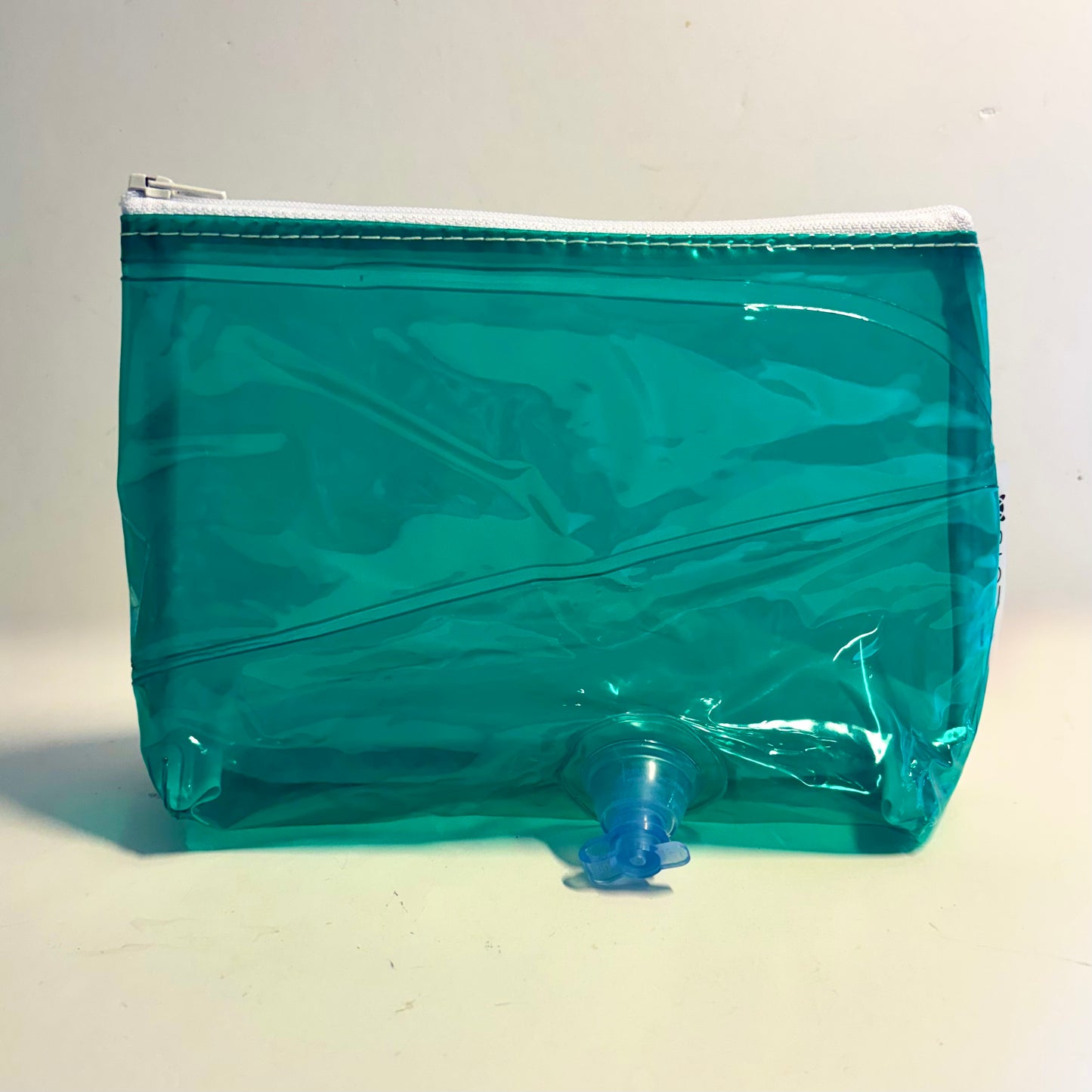 Upcycled cosmetics purse handmade from repurposed pool inflatables using recycled PVC plastic.